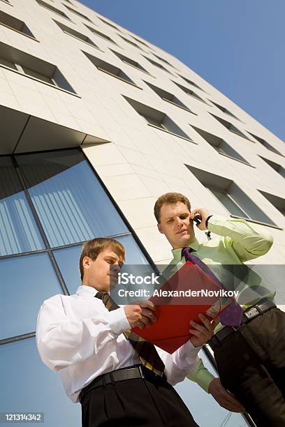 Two Successful Businessmen In Front Of The Modern Office Building Stock Photo - Download Image Now