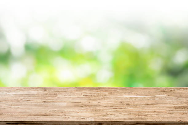 istock light brown wood table on green bokeh background 1213144601