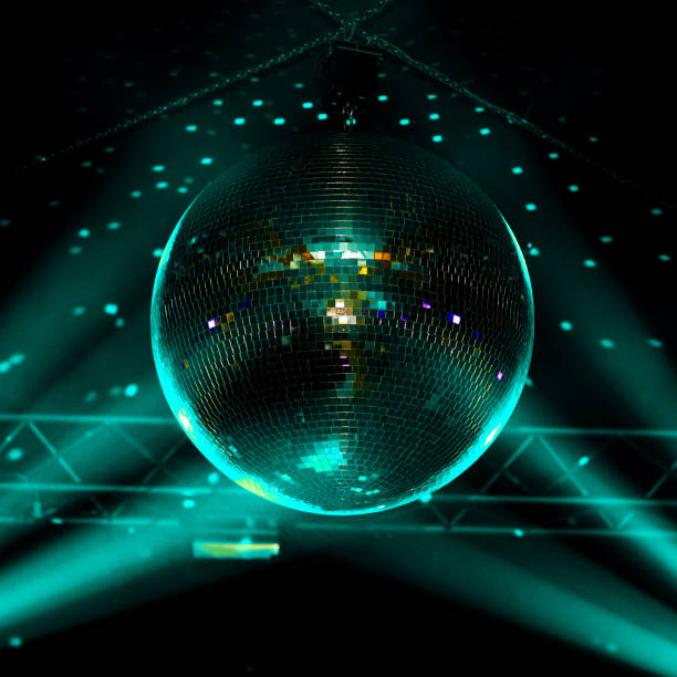 istock Closeup blue-green light disco ball with dots on wall, night club background. 1213145229