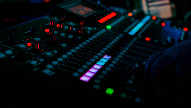 istock Closeup pro audio digital mixing console in dark club with spotlights 1213146262