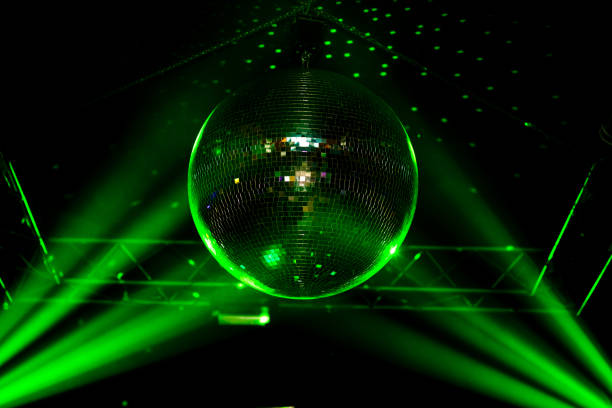 istock Green light disco ball with dots on wall and rays, night club background. 1213146280