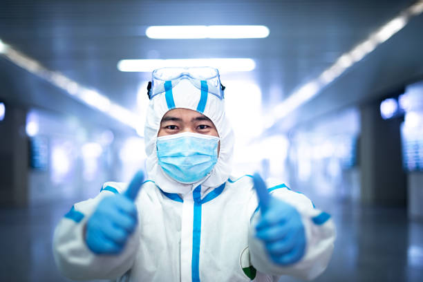 COVID-19 medical worker wearing protective clothing stock photo