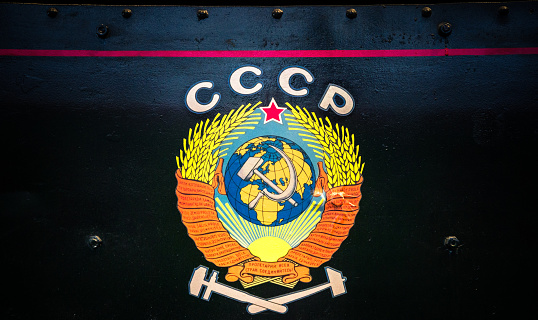 Old retro former Soviet Union coat of arms on wall of train locomotive
