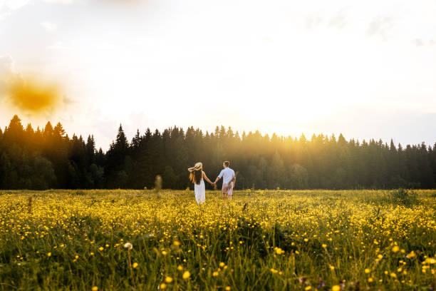 istock Running loving couple in the field. Sunset. 1213148639