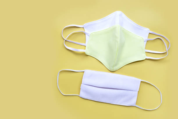 istock Handmade cloth masks on yellow background. 1213149310