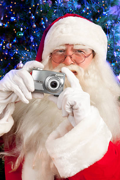 istock Santa Claus holding a digital camera. 121315037