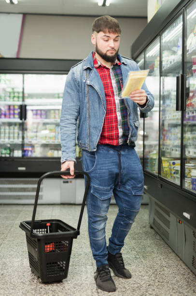istock man shopping in grocery store, looking for hard cheese 1213150989