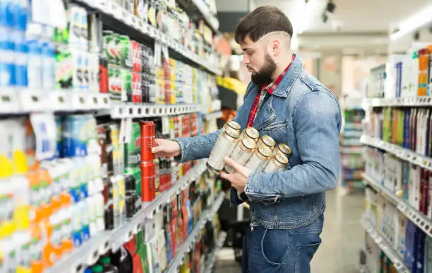 Photo of man shopping canned beer