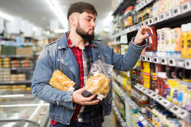 istock Focused man looking for healthy pasta sauce 1213151177