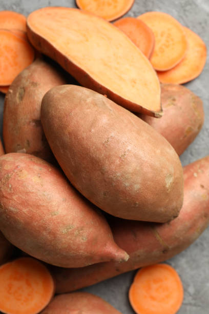 istock Sweet potato on grey background, top view. Vegetables 1213152611