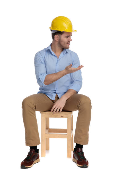 istock Serious casual man wearing hard hat, disagreeing and gesturing 1213152874
