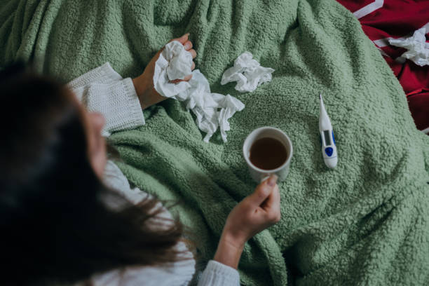 istock Woman sick in bed, covered with blanket 1213153060