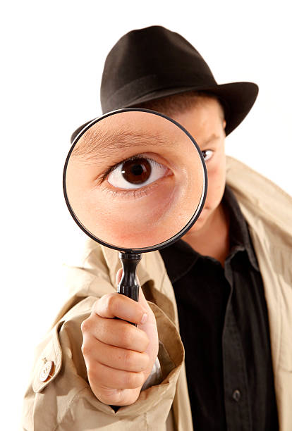 istock Detective kid investigate with magnifying glass 121315315