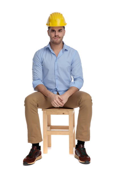 istock Bothered casual man frowning and wearing hard hat 1213153461