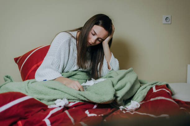 istock Woman sick in bed, covered with blanket 1213153488