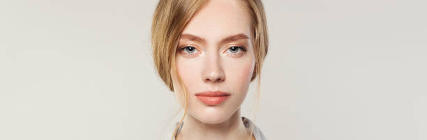 istock Young woman face closeup on white banner background 1213153867