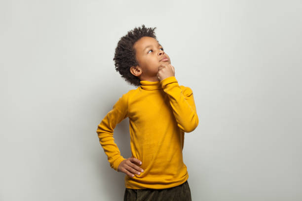 Curious black child looking up on white background