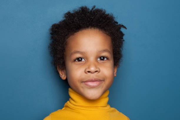 istock Cute black kid face on blue background 1213154211