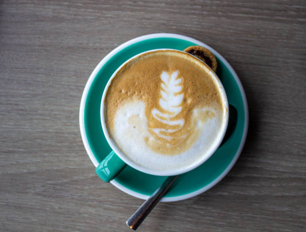 istock cappuccino cup on the brown wooden table. 1213154556
