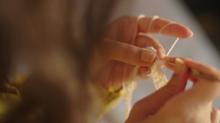 View of knitting with white yarn.