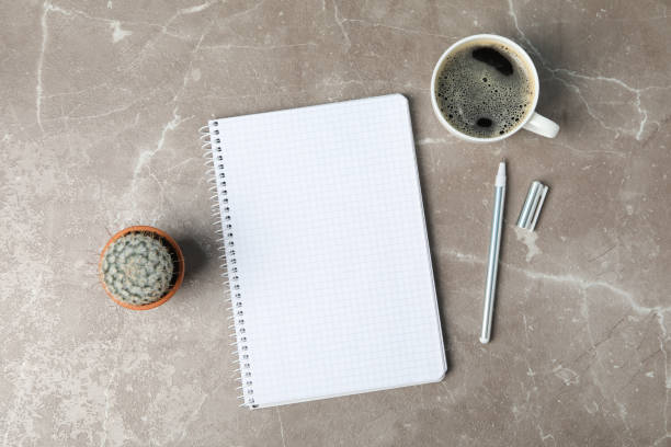 istock Notebook, coffee, pen and cactus on grey background, top view 1213160899