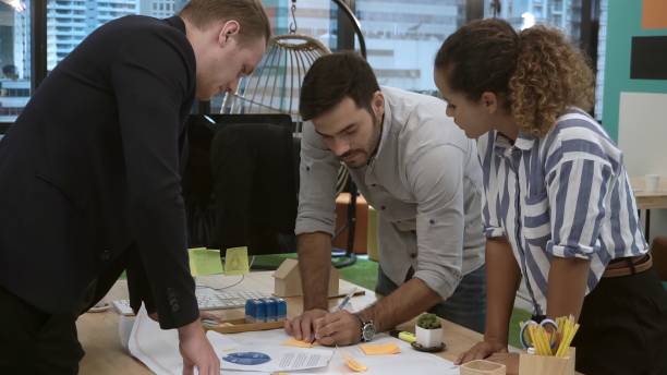 istock Creative business people group having conversation at office desk in workplace. 1213160963