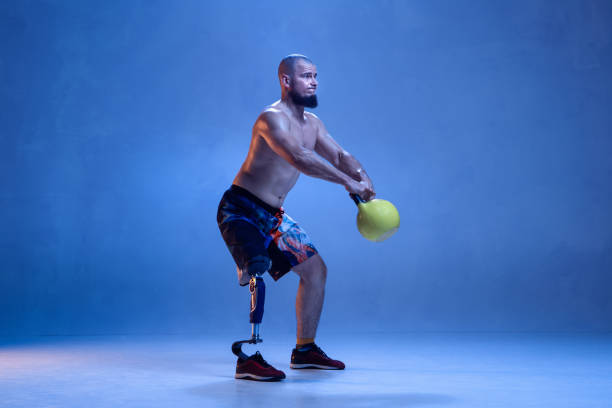 istock Athlete disabled amputee isolated on blue studio background 1213162720
