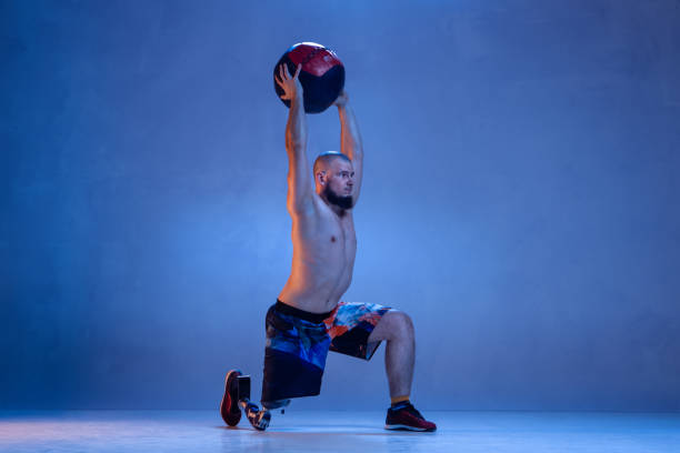 istock Athlete disabled amputee isolated on blue studio background 1213162768