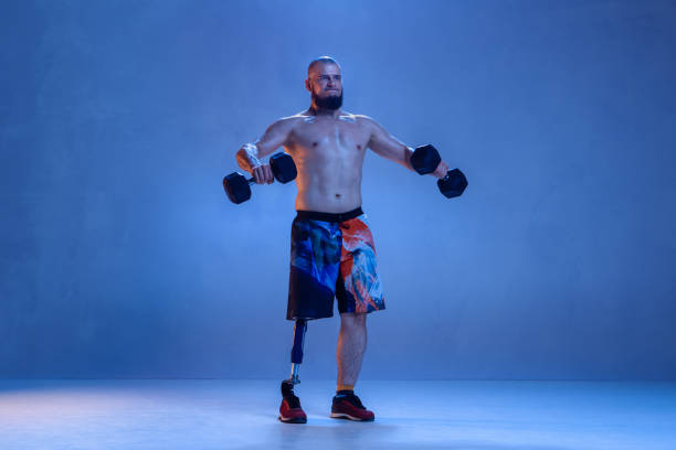 istock Athlete disabled amputee isolated on blue studio background 1213162774