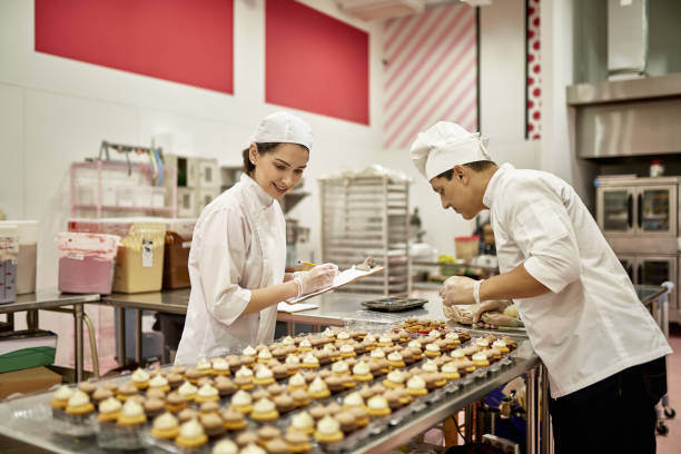 istock Bakers Icing Vegan Cupcakes and Performing Quality Control 1213165147