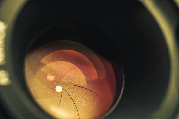 istock Beautiful camera lens with orange  light of glass. Background pattern for design. 1213165220