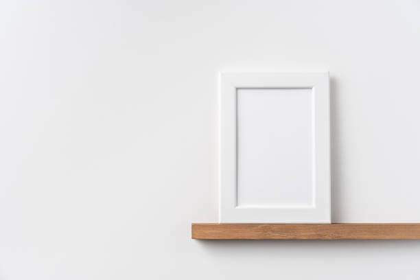 istock vertical white wood photo on bookshelf and wall 1213165332