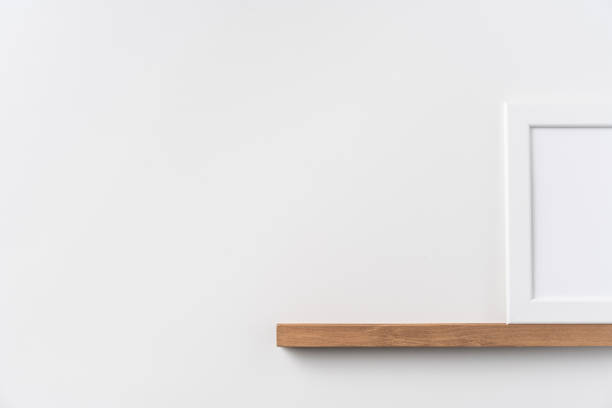 istock vertical white wood photo on bookshelf and wall 1213165452