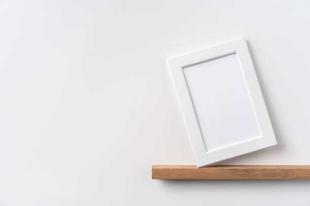 istock vertical white wood photo on bookshelf and wall 1213165999