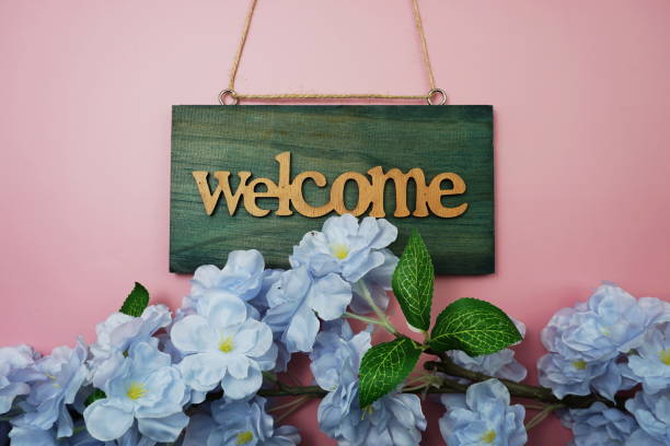 istock Welcome Sign and Flower Blooming Decoration on pink background 1213169257