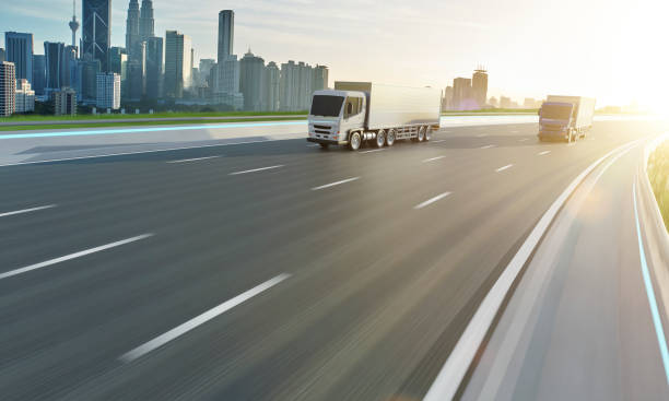 istock Two delivery truck run on the road 1213170475