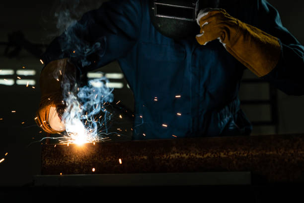 istock Metal welder working with arc welding machine. 1213171858
