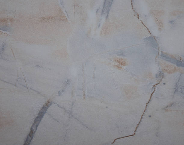 istock Beige light marble, watered surface of natural stone close up. 1213176430