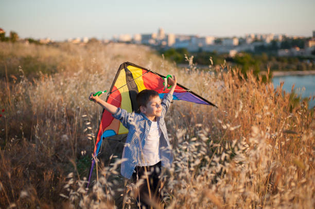 istock happy dreaming cute kid with kite in hands above head eyes closed 1213178584