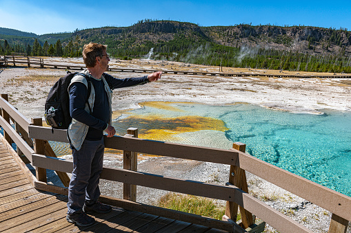 Elderly man standing, watching Green Spring Lake and Yellowstone Wyoming USA,Nikon D3x
