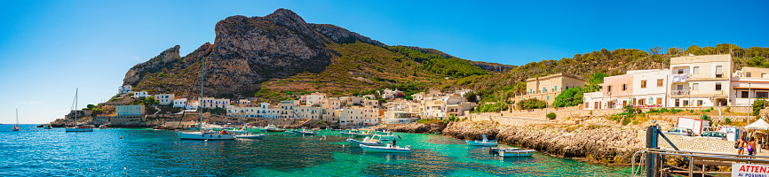 A veiw of Levanzo Island, Sicily, ItalyLevanzo, Italy - 16 august 2016: boats, yachts, ferries, etc. anchored in the crystal clear sea of the port of Levanzo Island, Sicily, Italy