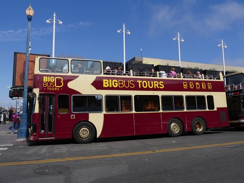 San Francisco, California-July 2018: A Big Bus hop on hop off tour bus parked on the curb loading tourists in San Francisco.