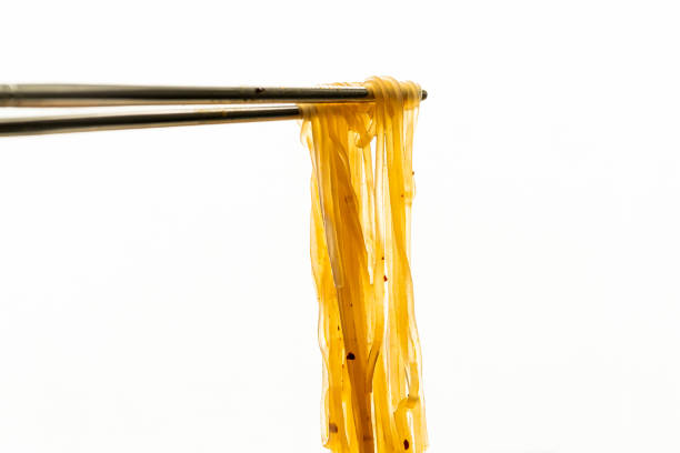 Asian instant noodle with chopsticks in ceramic bowl on white background