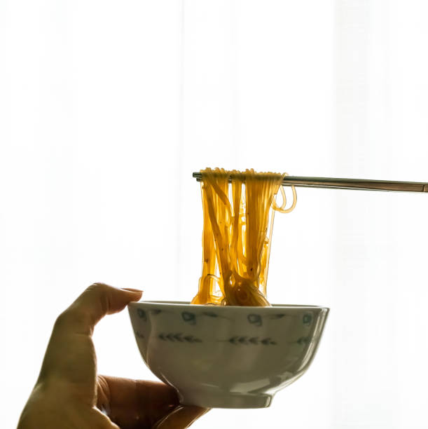 istock Asian instant noodle with chopsticks in ceramic bowl on white background 1213182815