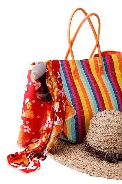 istock Beach items: colorful striped bag, bright kerchief, sunglasses a 121318425