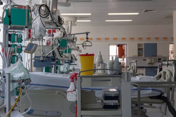 istock Intensive care unit in hospital, beds with monitors, ventilators, a place where can be  treated patients with pneumonia caused by coronavirus covid 19. 1213184880