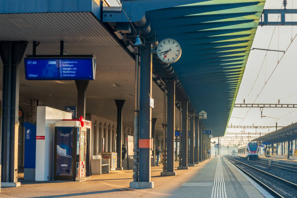 at 8 a.m. at the Solothurn railway station. The train station and platforms are almost deserted. Almost no commuters or travelers are out and about during rush hour. stock photo