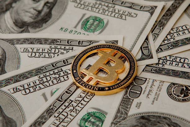 istock Golden Bitcoin on US dollar bills. Electronic money exchange concept 1213185923