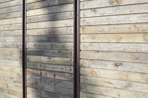 istock Wooden texture background with vertical metal bars in sunlight 1213185933