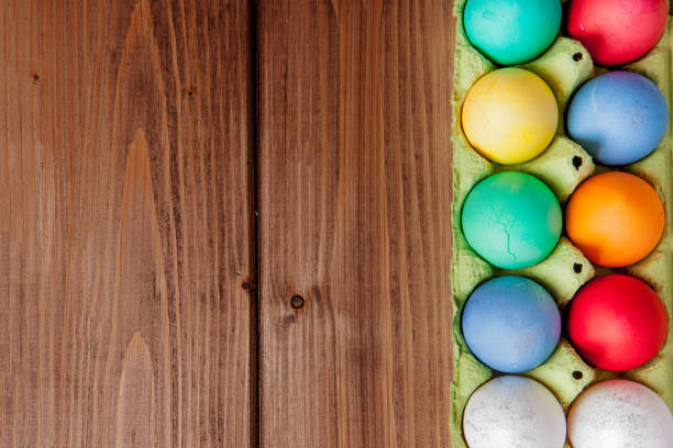 istock Colorful Easter eggs in box on wooden background with copy space 1213186212